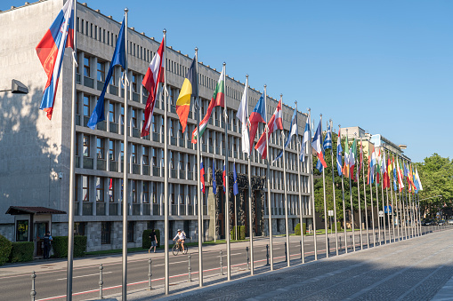 Ljubljana, Slovenia - June 14, 2021: All of EU flags in front of the Slovenian Parliament as  Slovenia will take over the Presidency of the Council of the European Union on 1 July 2021.