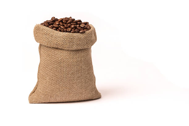 istock Roasted brown coffee beans. In a burlap sack. On white background. 1323547203