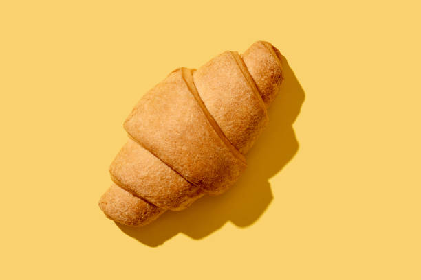 istock Delicious fried croissant. Bun for breakfast. Tea snack. 1323547263