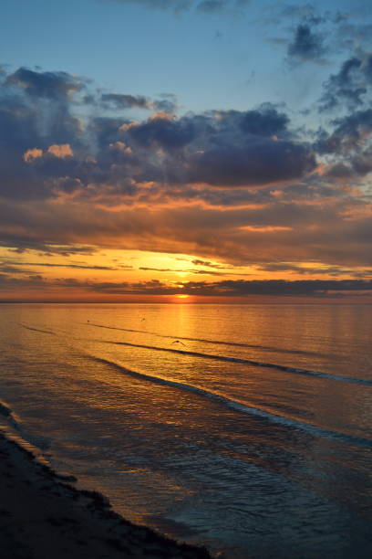 istock Evening summer scenery view. Colorful clouds on sunset, beautiful reflection on sea water 1323547453