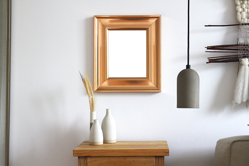 A wide rose gold frame on a wall. Room for your image.