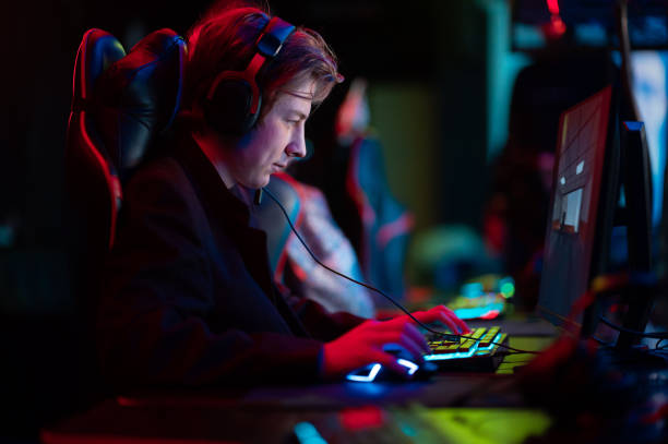 istock A young guy in a headset plays shooting games in the computer room 1323548634