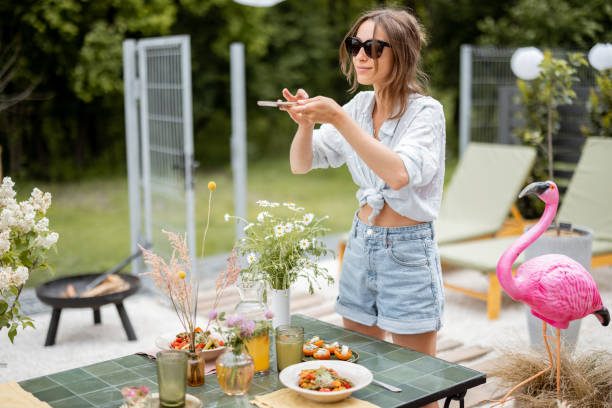 istock Woman decorating dining table outdoors 1323548735