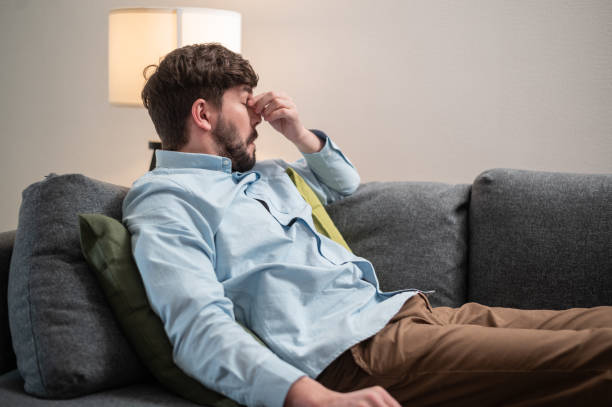 istock During the lunch break, a young bearded worker lay down on the sofa to sleep 1323549224