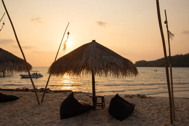 istock Summer vacation concept. Beautiful silhouette empty sun bed sunset or sunrise on the beach in Phuket, Thailand. 1323549965