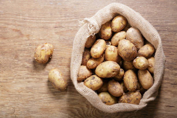 istock fresh potatoes in a sack on wooden table 1323550091