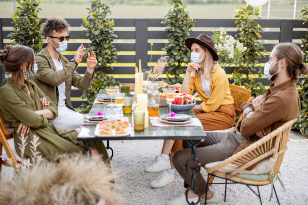 istock Friends in face mask dining outdoors 1323550270