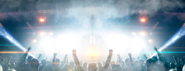 concert spectators in front of a bright stage with live music - concert hall crowd dancing nightclub imagens e fotografias de stock