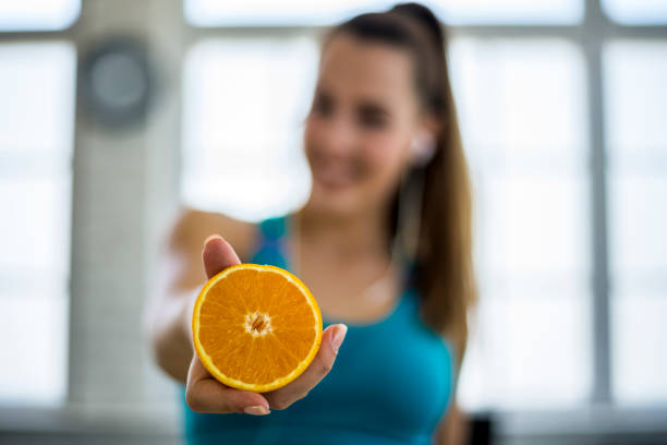 istock Young woman making detox smoothie at home 1323556964