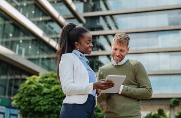 istock Multi ethnic stock market experts in financial district outdoors - teamwork in sustainable environment 1323557585