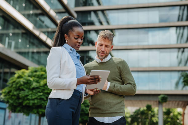 istock Multi ethnic business people in financial district outdoors - teamwork in sustainable environment 1323557641