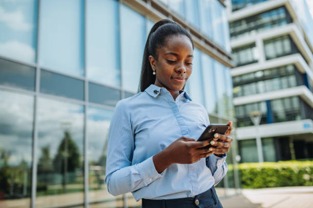 istock African businesswoman in financial district outdoors, using mobile phone 1323558048