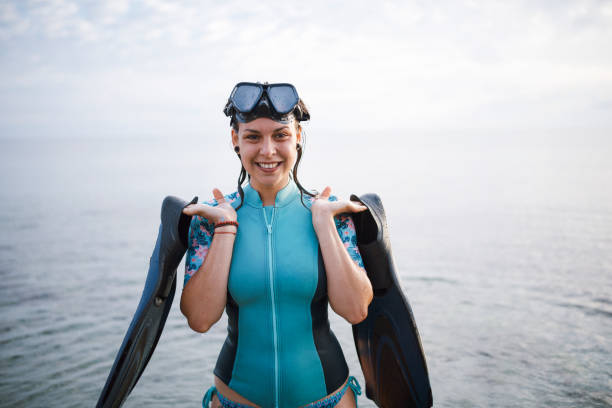 Rear view of a woman going snorkeling.