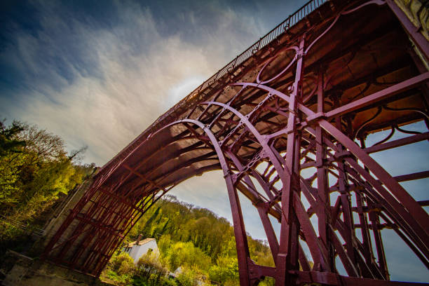 Ironbridge Telford The ironbridge in Telford in red, low and wide from the coalbrookdale side ironbridge shropshire stock pictures, royalty-free photos & images