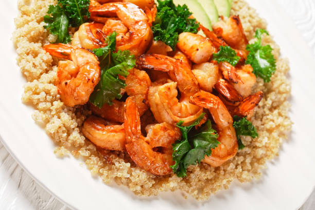 istock grilled spicy prawns served with quinoa, kale and avocado on a white plate 1323559100