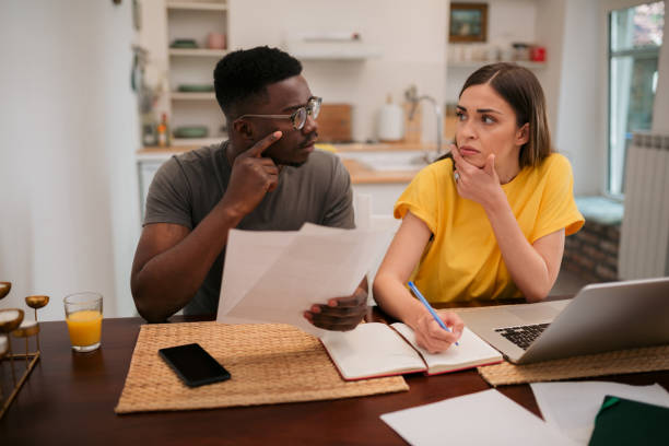 istock Young diverse couple doing their finances at home 1323561227