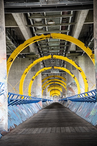 Vienna, Austria - 05 22 2021: a footbridge across the river Danube in Vienna in diminishing perspective