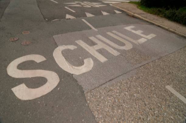 istock school route marking in german (Schule) on the road 1323563709