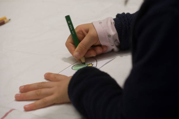 istock a child painting or drawing 1323563756