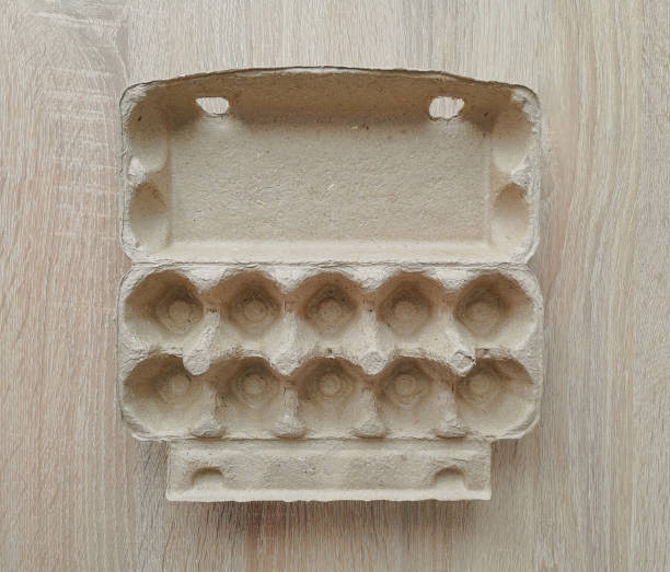 istock Cardboard egg box. Empty egg carton. Eggs box. Empty box of 10 eggs on a wooden table 1323563762