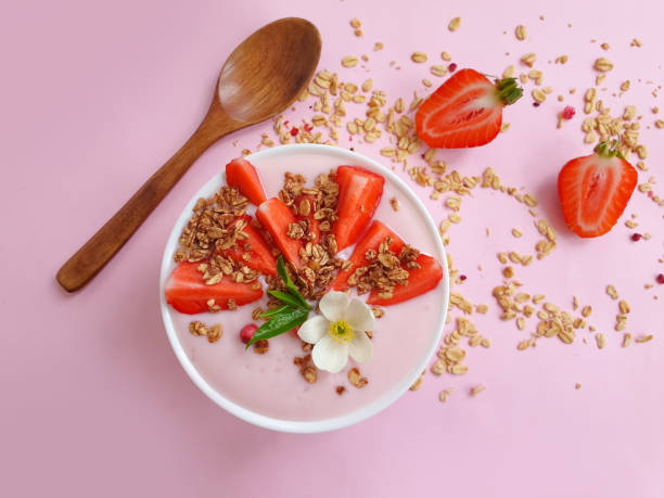 istock yogurt, granola, strawberry, blueberry on a colored background 1323567103