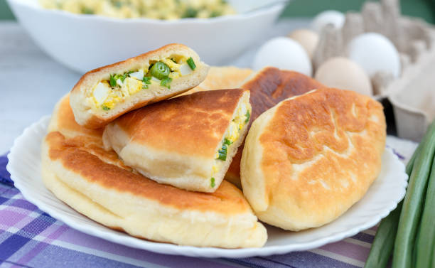 istock Fried yeast pies stuffed with green onions and eggs, selective focus 1323568279