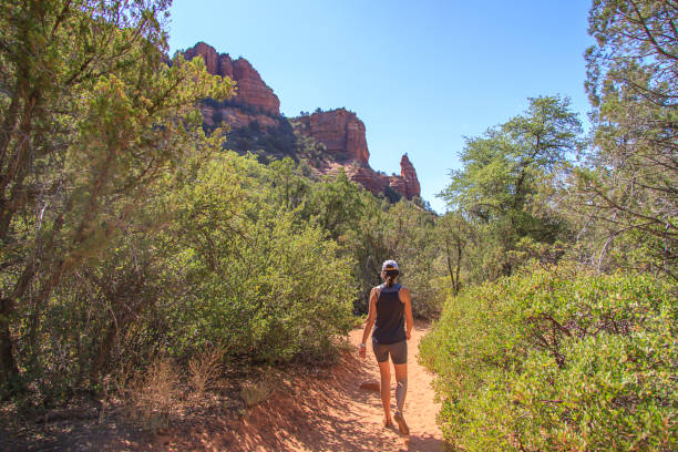istock Woman hiking on a desert path through a canyon 1323569292