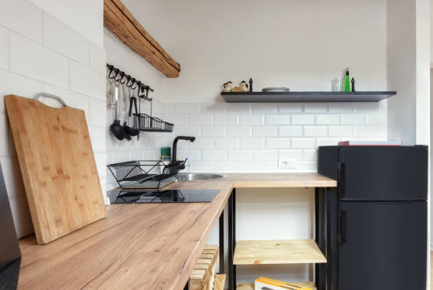 istock Attic apartment, modern kitchen, apartment interior design with old rustic wooden beams and furniture, stylish Italian granite ceramica. 1323569497