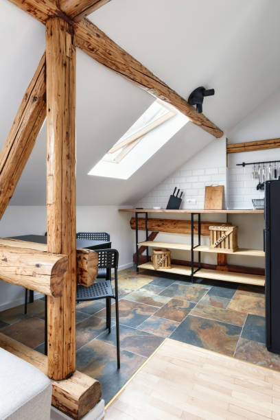 istock Attic apartment, modern kitchen, apartment interior design with old rustic wooden beams and furniture, stylish Italian granite ceramica. 1323569511