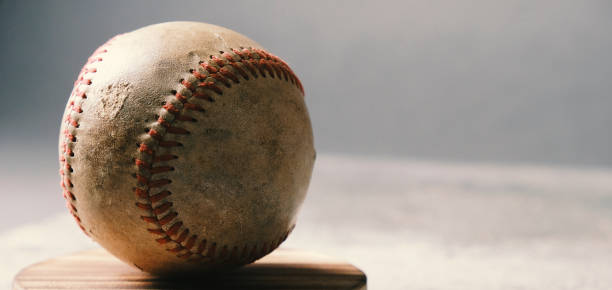 istock old and worn baseball ball on background 1323569713
