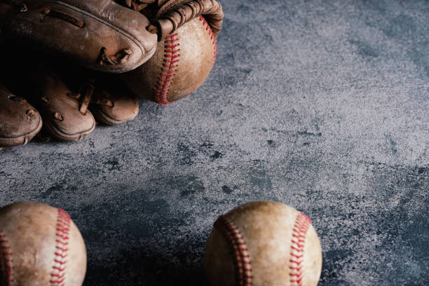 istock Baseball background with copy space by old used equipment 1323569714