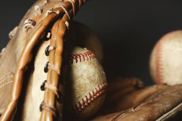 istock baseball ball and glove background 1323569720