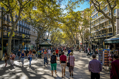 The Ramblas.  People stroll through the Ramblas shopping and enjoying a beautiful day in Barcelona Catalonia Spain October 2015