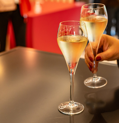 Tasting of cold brut Champagne sparkling wines in underground cellars of wine house in Reims, Champagne, France