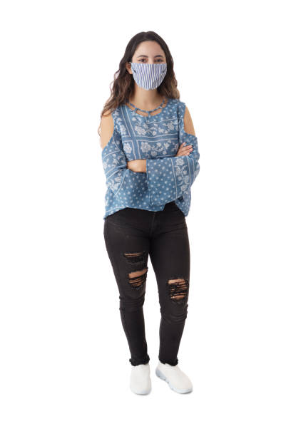 istock Woman looking at camera wearing protective face mask 1323577020