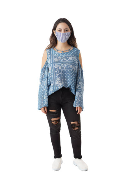 istock Young woman standing with mask and looking at camera 1323577092