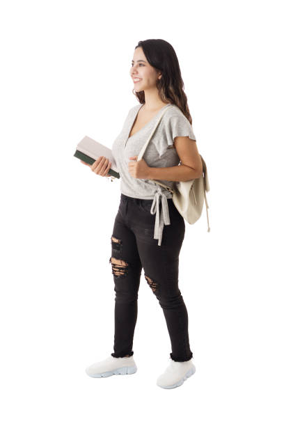 istock Female student walking with bag and books 1323578276