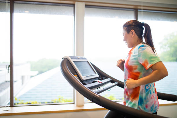 istock A woman running on a treadmill at a gym 1323581796