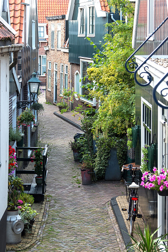 Volendam, Netherlands - July 11 2021: A quiet residential street next to Volendam Haven area waterfront
