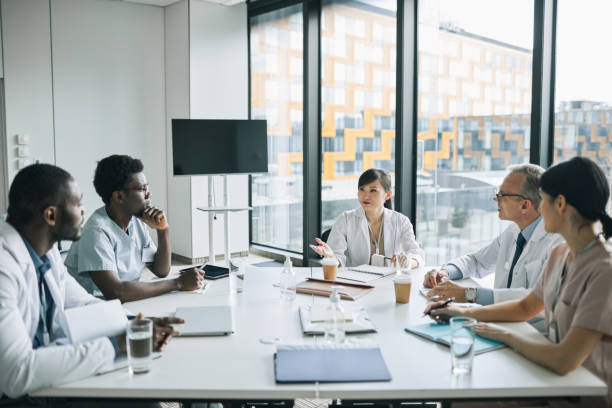 istock Group of Medics at Meeting Table 1323582800