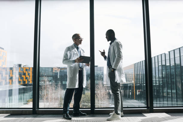 istock Doctors Talking at Medical Clinic Wide Angle 1323582814