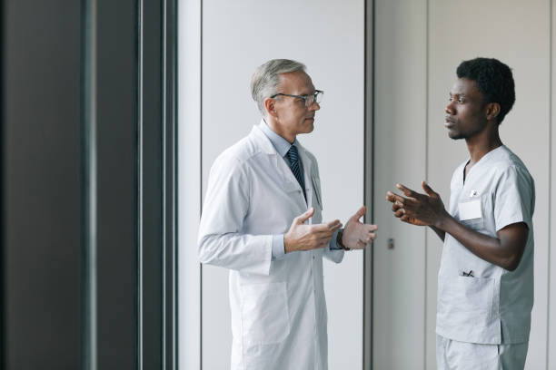 istock Mature Doctor Talking to Intern in Clinic 1323582844