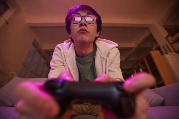 istock Asian Man Playing Video Games 1323584220