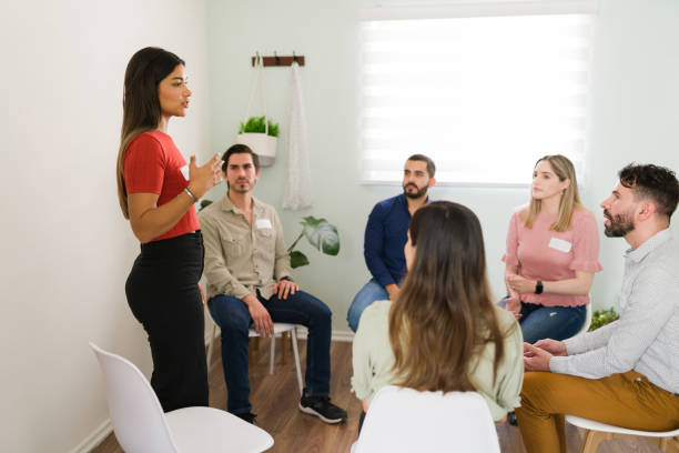 istock Hispanic woman introducing herself at an AA meeting 1323584420