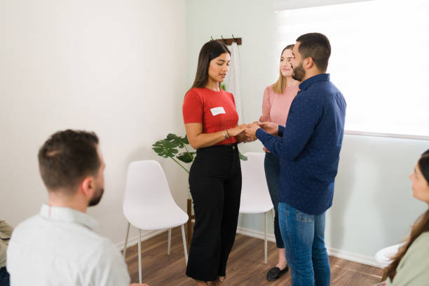 istock Therapist making a new exercise at group counseling 1323584972