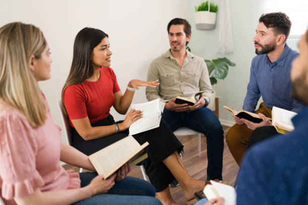 istock Young happy people discussing a new book 1323585189