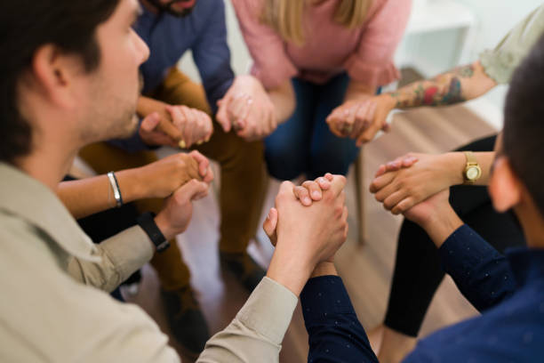 istock Praying to solve our addictions at alcoholic anonymous 1323585841