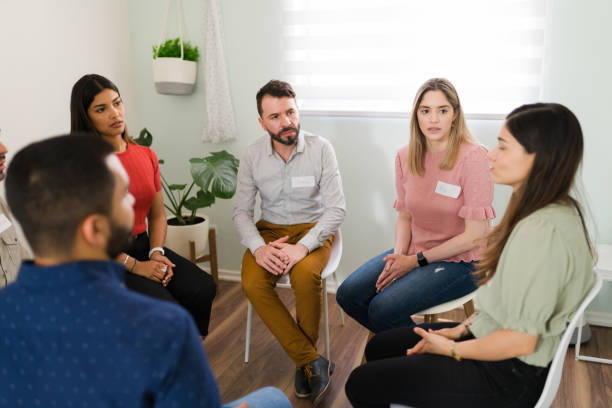 istock Beautiful woman attending a group support 1323586027