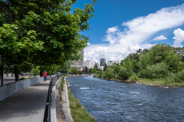 Reno, NV USA - May 16, 2021: People walking along the Truckee River in downtown Reno.