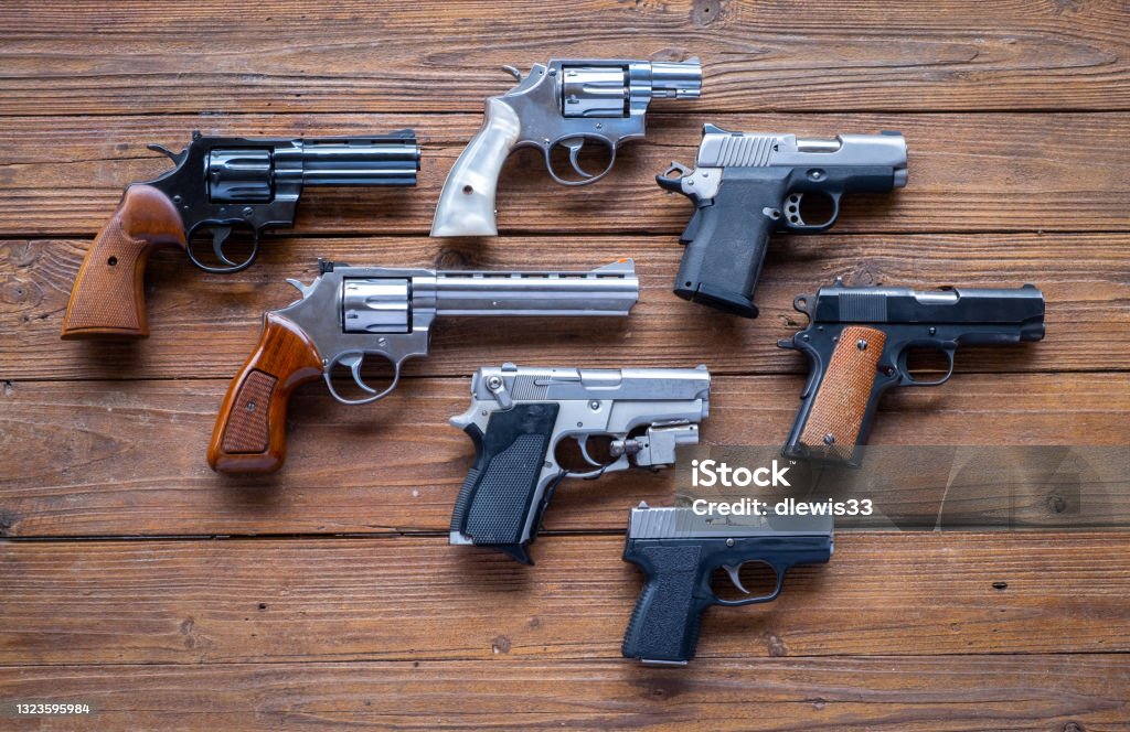 Collection of Handguns Seven handguns, some revolvers, some semi-automatic, in different calibers. Gun Stock Photo